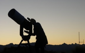 A stargazer uses a telescope at Tekapo's Mount John Observatory.