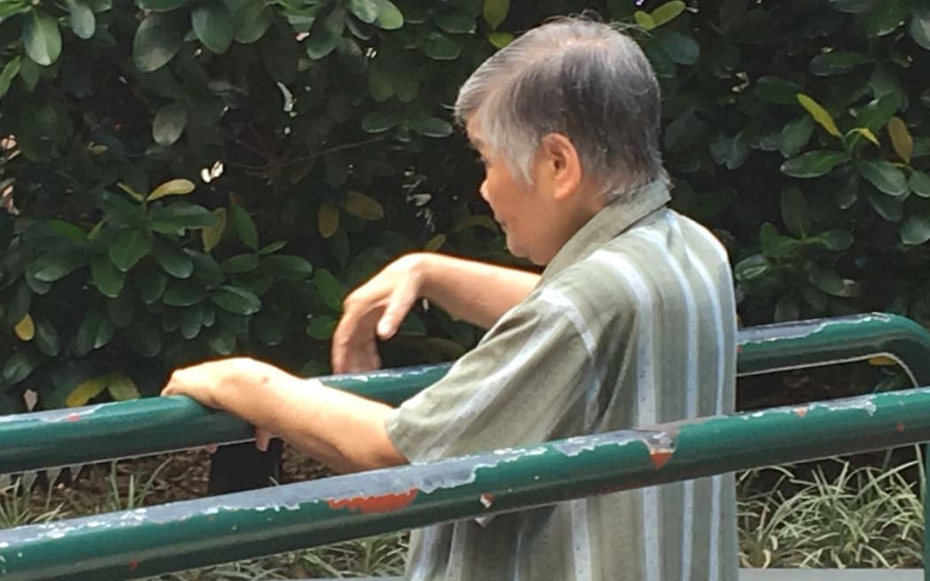 An elderly woman exercising at a public park in Hong Kong