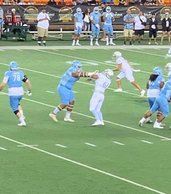 Samoa's Belford Viali on the receiving end of a big fend during the Polynesian Bowl in Hawaii.