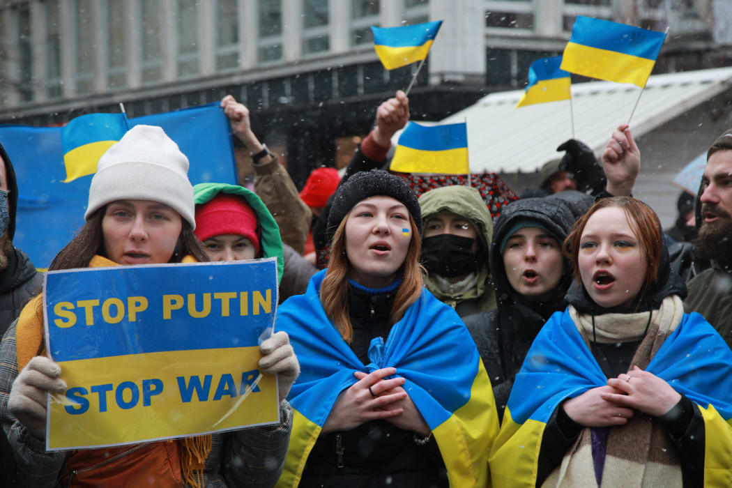 People, holding banners and flags, gather to hold a solidarity protest against Russia's attacks on Ukraine in Belgrade, Serbia on 6 March 2022.