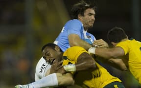 Marcelo Bosch is tackled by Australia's Tevita Kuridrani.