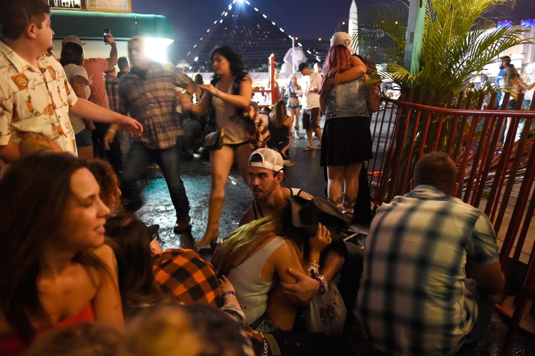 People take cover as gunfire is heard.