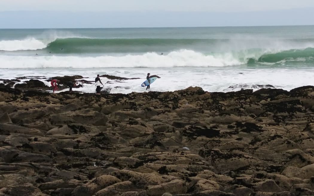 Surfers at Whale Bay near Raglan.