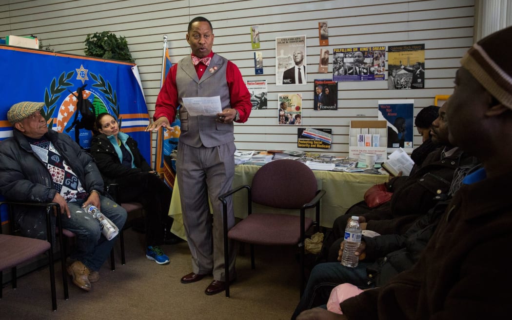 New York City Council member Andy King (centre), with people waiting to sign up in the Bronx on Monday.