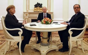 French President Francois Hollande (R), Russian President Vladimir Putin (C) and German Chancellor Angela Merkel (L) meet at the Kremlin in Moscow.