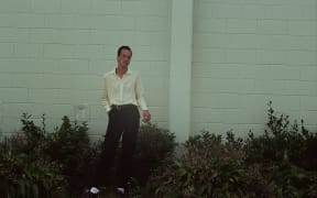 Marlon Williams poses with his hand tucked loosely in his pocket