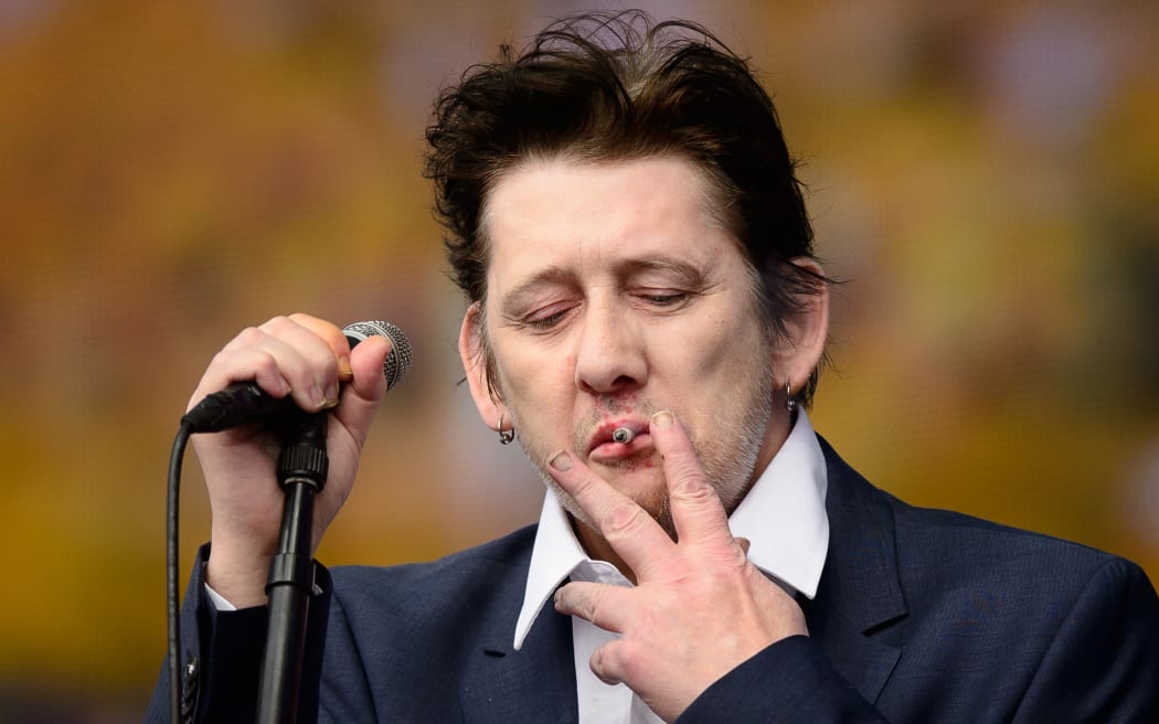 Shane MacGowan of British group The Pogues performs on stage at the British Summer Time festival in Hyde Park in central London, on 5 July, 2014. MacGowan, songwriter and lead singer of folk-punk group The Pogues, has died aged 65 after a long illness, his wife announced on 30 November, 2023.