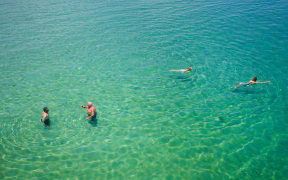 Swimmers cool off at Brighton Beach in Adelaide.