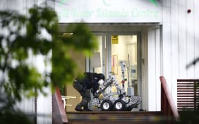 A Norwegian police expert manipulates a robot in front of the Al-Noor Islamic Centre where a gunman opened fire, injuring one person.