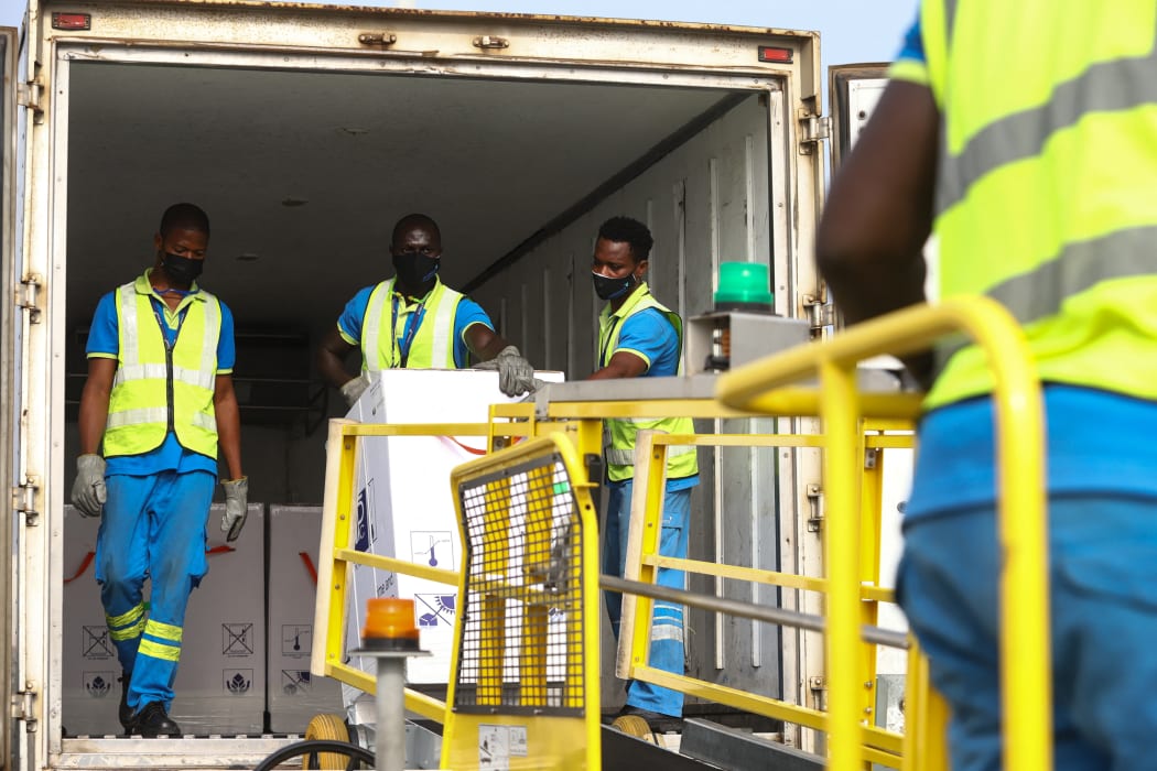 Airport workers unload a shipment of Covid-19 vaccines from the Covax programme, at Kotoka International Airport in Accra, 24 February 2021.