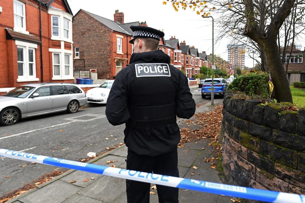 A police officer works inside a cordoned-off area on Rutland Avenue, the place where police have confirmed the passenger of the taxi that later exploded outside the Women's Hospital in Liverpool was picked up, on 15 November 2021.