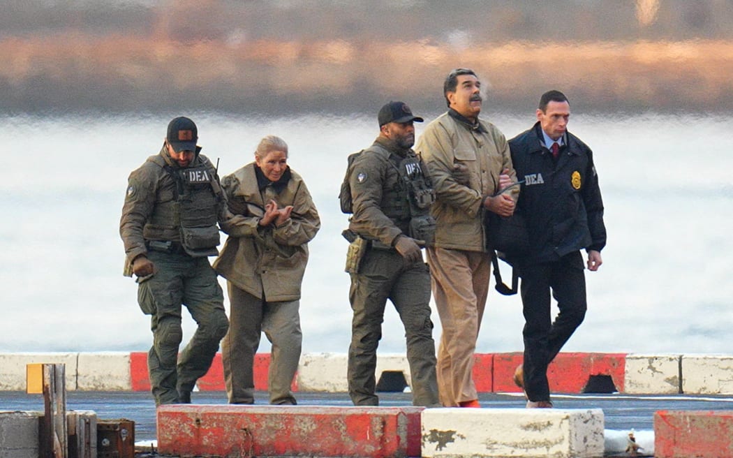 NEW YORK, NY - JANUARY 5: Nicolas Maduro and his wife, Cilia Flores, are seen in handcuffs after landing at a Manhattan helipad, escorted by heavily armed Federal agents as they make their way into an armored car en route to a Federal courthouse in Manhattan on January 5, 2026 in New York City.  (Photo by XNY/Star Max/GC Images)