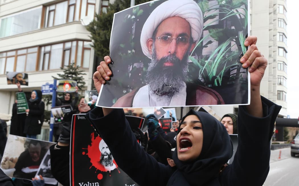 Demonstrators hold pictures of Shiite cleric Sheikh Nimr al-Nimr as they protest outside the Saudi Embassy in Ankara to protest against the execution by Saudi Arabia of the prominent Shiite cleric.