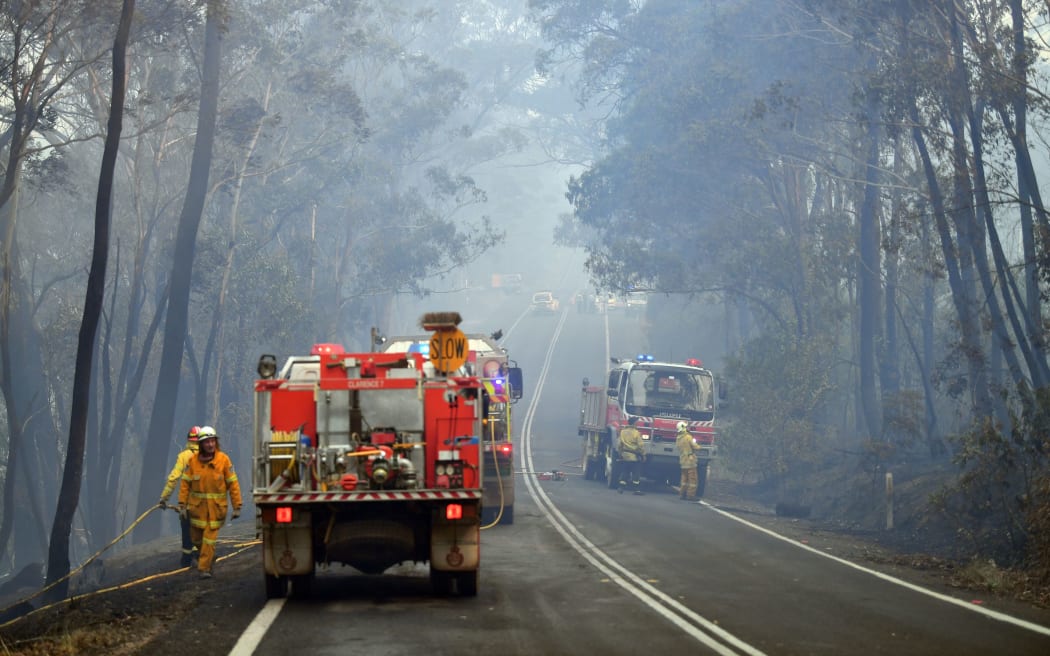 Firefighters work to extinguish a bushfire in Dargan, some 120 kilometres from Sydney, on December 18, 2019.