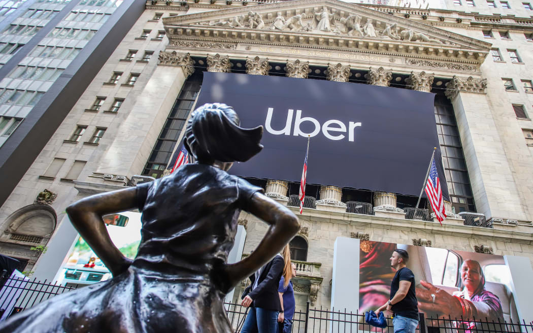 An Uber banner adorns the facade of the New York Stock Exchange ahead of the ride sharing company's IPO.