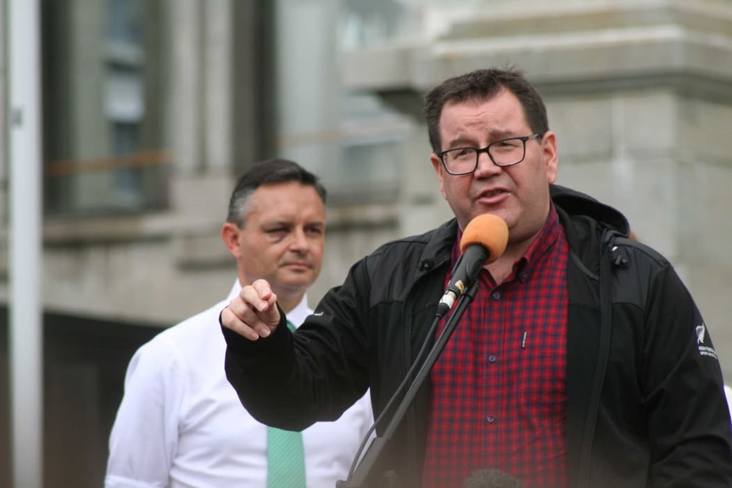 New Zealand Finance Minister Grant Robertson (with Climate Change Minister James Shaw behind him) speaks to thousands of students and others who marched to parliament demanding urgent action on climate change.