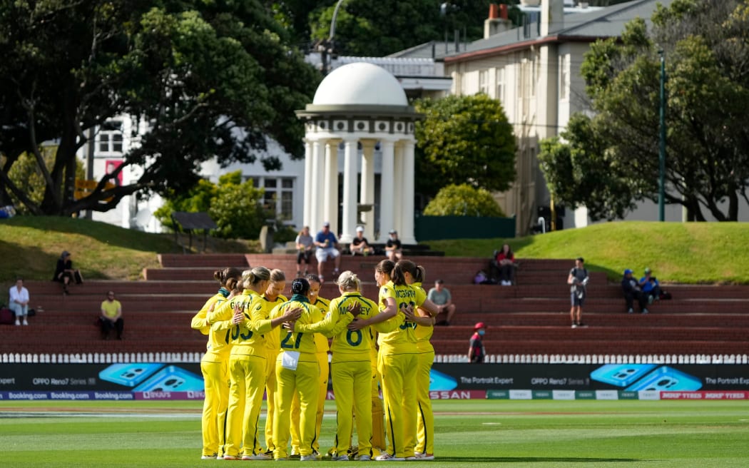 The Australian women's cricket team huddle before their World Cup game against South Africa at the Basin Reserve, 2022.