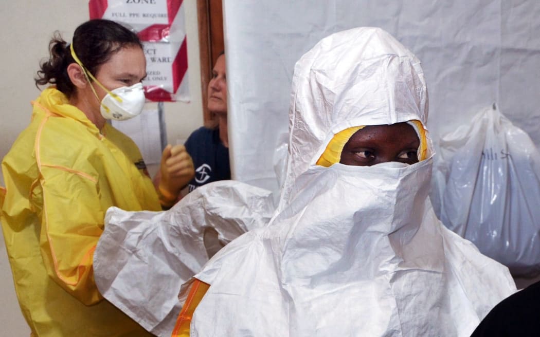 Staff of charity Samaritan's Purse put on protective gear at a hospital in Liberia, which is one of several countries battling West Africa's deadly Ebola outbreak.