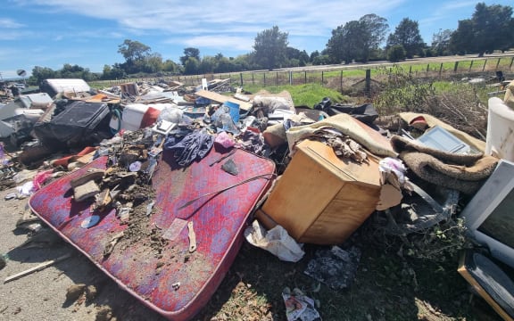 The other route into the industrial zone via Awatoto Road is closed. Residents are volunteers have been bringing trailer load after trailer load of waste and ruined furniture to an informal dump site on the corner of Eriksen and Awatoto roads. They say the local council knows about it and plans to clear it.