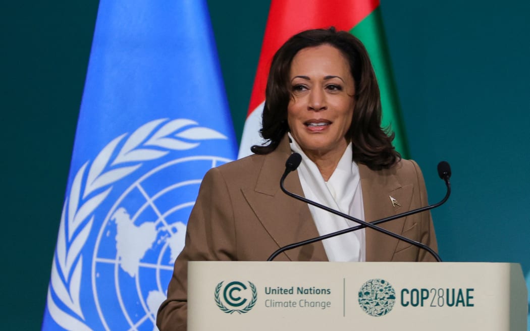 US Vice President Kamala Harris arrives on stage to speak during the High-Level Segment for Heads of State and Government session at the United Nations climate summit in Dubai on December 2, 2023. The COP28 conference opened on December 1 with an early victory as nations agreed to launch a "loss and damage" fund for vulnerable countries devastated by natural disasters. (Photo by Giuseppe CACACE / AFP)
