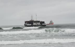 The Manahau sand barge being towed off Westport’s Carters Beach