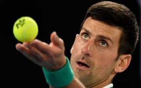 (FILES) In this file photo taken on February 21, 2021 Serbia's Novak Djokovic serves against Russia's Daniil Medvedev during the men's singles final on day fourteen of the Australian Open tennis tournament in Melbourne.