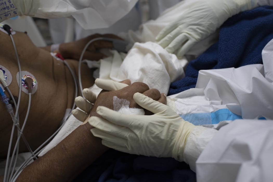 Health workers fight to save the life of a Covid-19 patient in the intensive care unit of El Salvador Hospital, on 12 August 12, 2020.