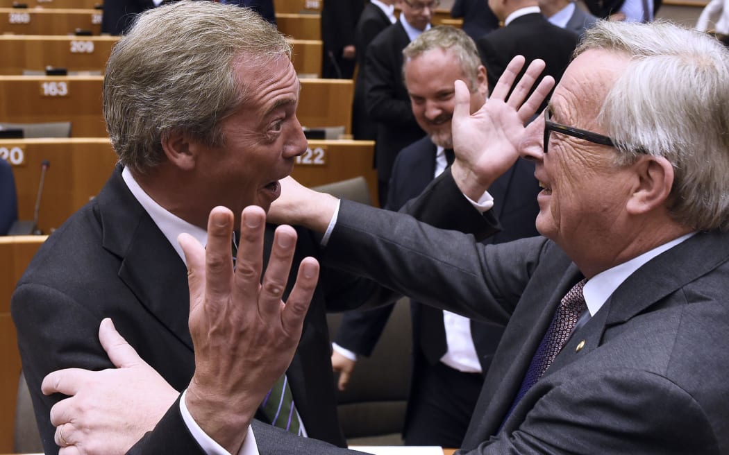 Nigel Farage (L) reacts as he meets European Union Commission President Jean-Claude Juncker at the EU headquarters in Brussels.