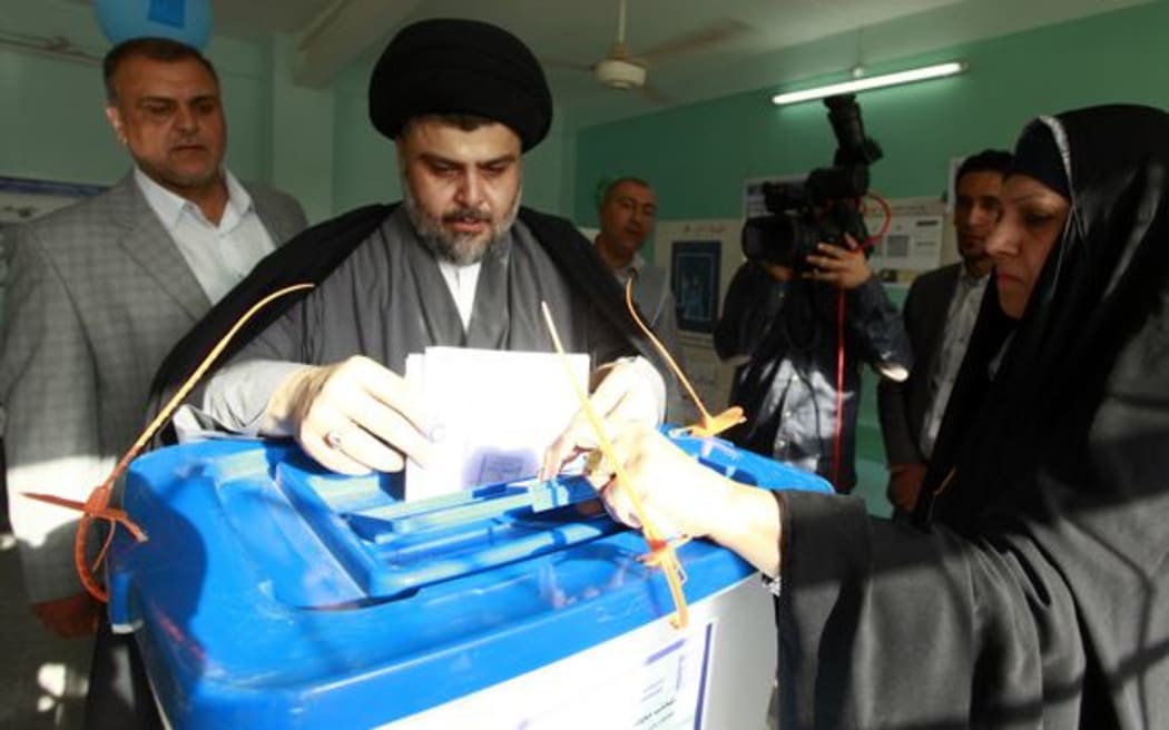 Shiite cleric Moqtada al-Sadr casts his vote in Iraq's first parliamentary election since US troops withdrew, at a polling station in the central Shiite shrine city of Najaf.