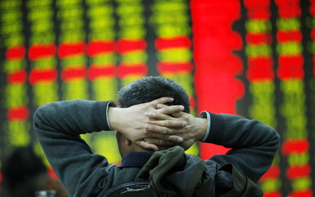 An investor watches an electric board in a stock market in Huaibei, Anhui, east China on 6 January 2016.