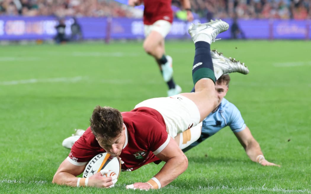 British and Irish Lions' Huw Jones dives to score a try during the rugby match between the British & Irish Lions and the NSW Waratahs.