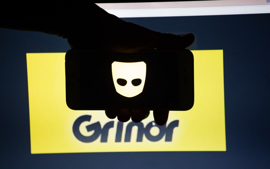 The logo of the dating app Grindr is seen on a mobile screen and a laptop screen. Grindr is a dating app for gay, bi, pan and curious men. Several Millions use Dating Apps every day.  (Photo by Alexander Pohl/NurPhoto) (Photo by Alexander Pohl / NurPhoto / NurPhoto via AFP)