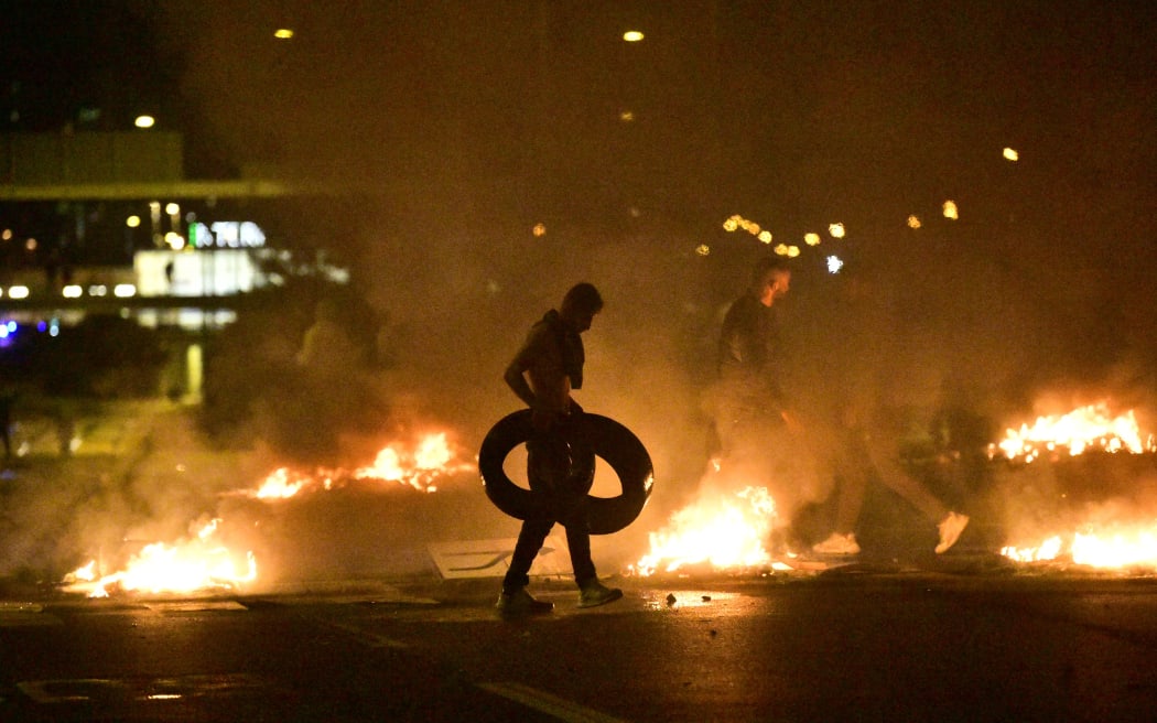 Demonstrators burn tyres during clashes with police in the Rosengard neighbourhood of Malmo, Sweden, on August 28, 2020.