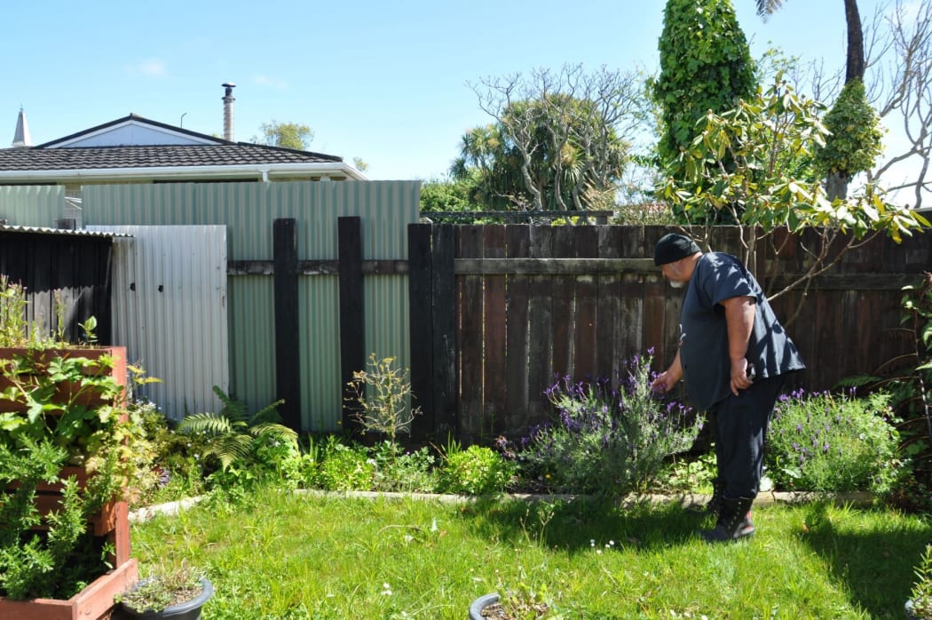 Pat Koti in the garden of his rental home that he has been unable to return to since the floods.