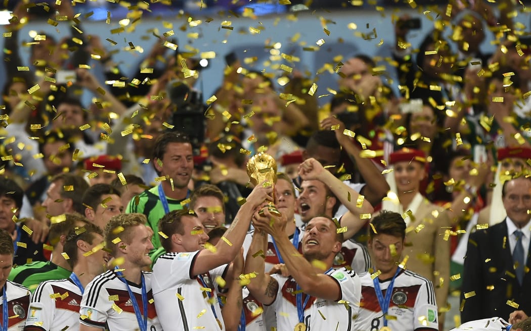 German players with the World Cup trophy snatched from Argentina in an extra-time win.