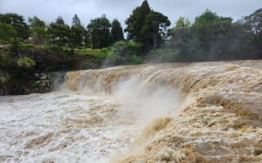 Floodwaters thunder over Haruru Falls, near Paihia in the Bay of Islands on 30 October, 2023.
