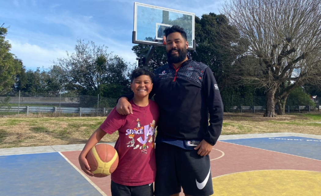 Mitchell Tomai and his son Madden at the basketball court.