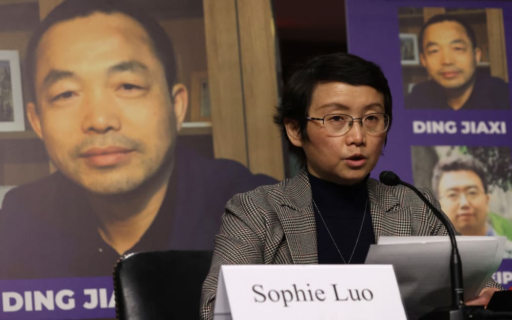 WASHINGTON, DC - FEBRUARY 03: As a photo of her husband Chinese human rights activist Ding Jiaxi is on display in the background, Sophie Luo testifies during a hearing before The Congressional-Executive Commission on China (CECC) at Dirksen Senate Office Building on Capitol Hill on February 3, 2022 in Washington, DC. CECC held a hearing on "The Beijing Olympics and the Faces of Repression."   Alex Wong/Getty Images/AFP (Photo by ALEX WONG / GETTY IMAGES NORTH AMERICA / Getty Images via AFP)