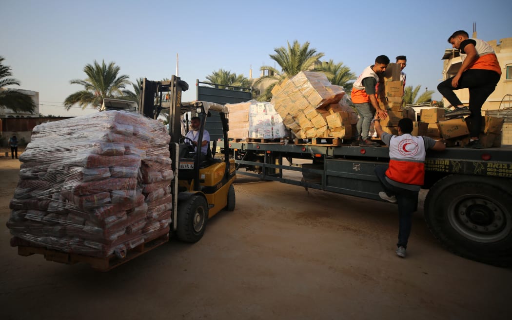 Red Crescent workers sort aid before being distributed to Palestinians, as the conflict between Israel and Palestinian Islamist group Hamas continues, in Khan Younis in the southern Gaza Strip, October 23, 2023.  (Photo by Majdi Fathi/NurPhoto) (Photo by MAJDI FATHI / NurPhoto / NurPhoto via AFP)