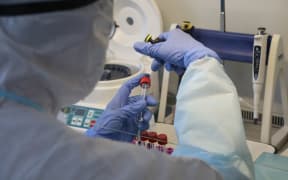 An employee wearing protective clothing does testings for the coronavirus at a laboratory as the spread of the disease continues, in Arkhangelsk, Russia.