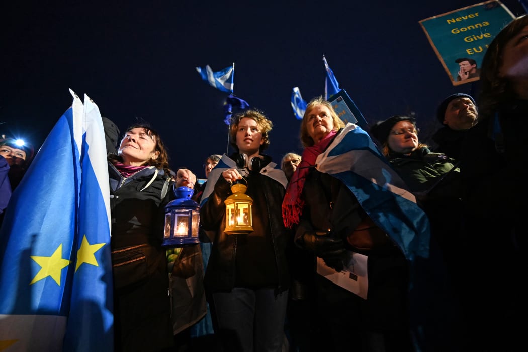 Protesters hold candle lamps during a protest by anti-Brexit activists in Edinburgh/