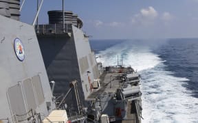 A file photo of a US Navy destroyer during a live-fire exercise on 2 February 2017.