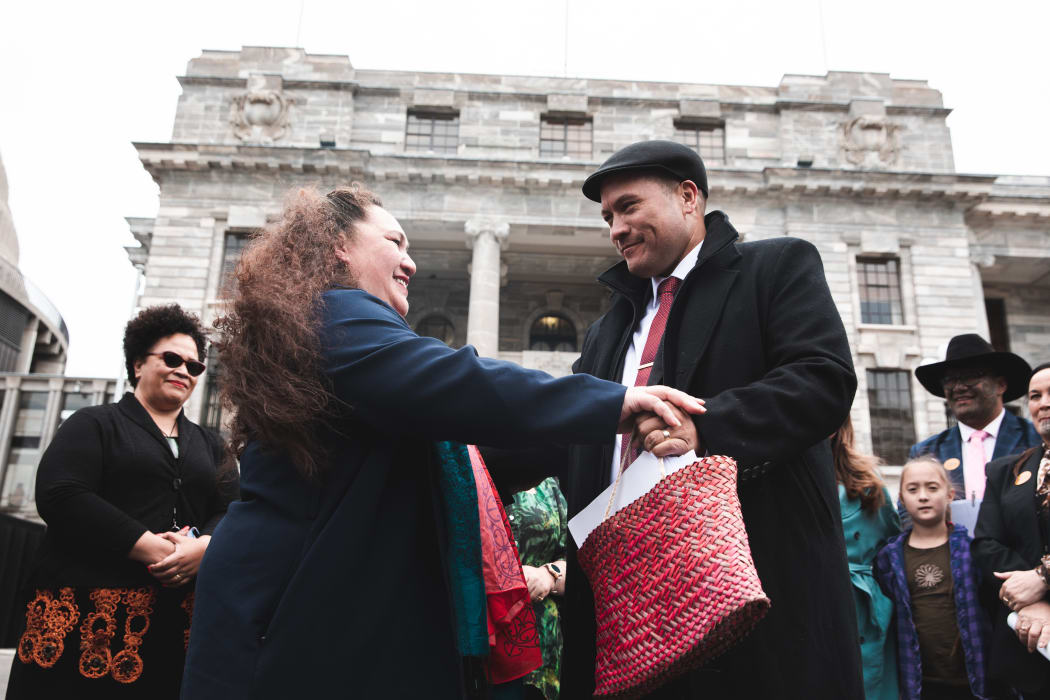 Toni Boynton from Te Rōpū Tautoko Māori handing the petition to Labour MP Tamati Coffey.