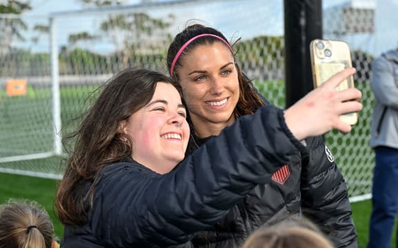Alex Morgan has a selfie taken with a fan at Bay City Park in Auckland