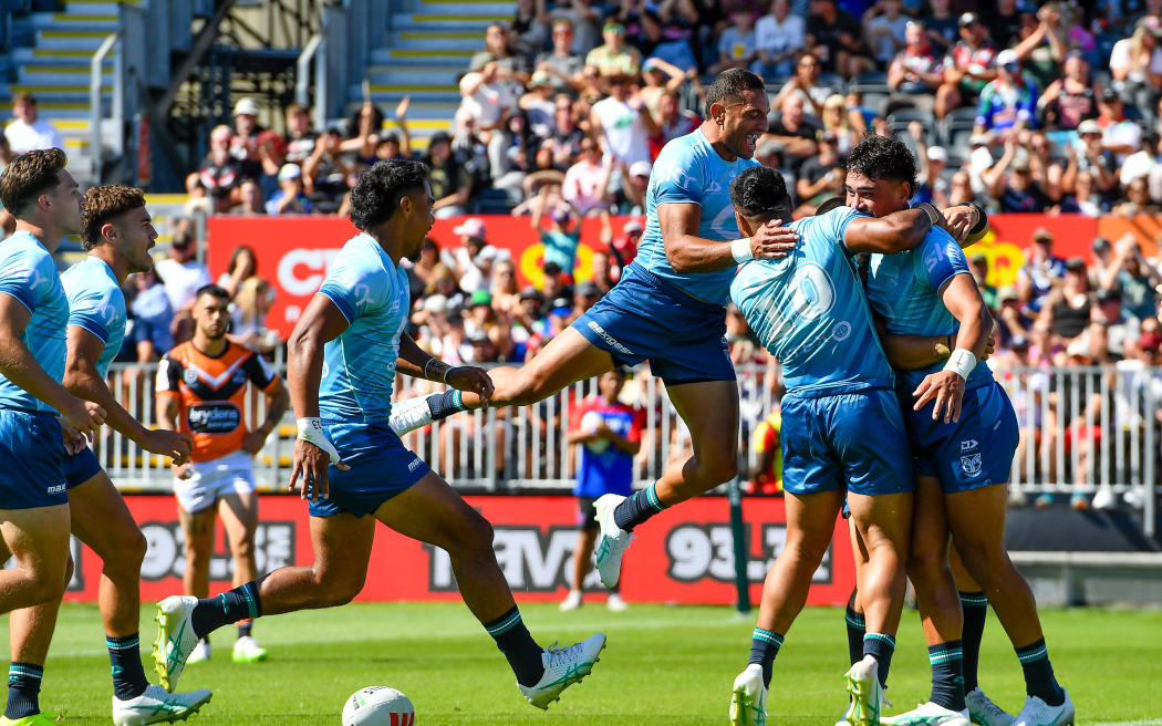 The Warriors celebrate Jacob Laban's try during the NRL preseason match against the Wests Tigers in Christchurch.