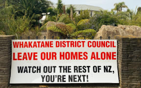 Some residents are not willing to go without a fight, as this sign on Rick, Rachel and Pam Whalley's fence attests.