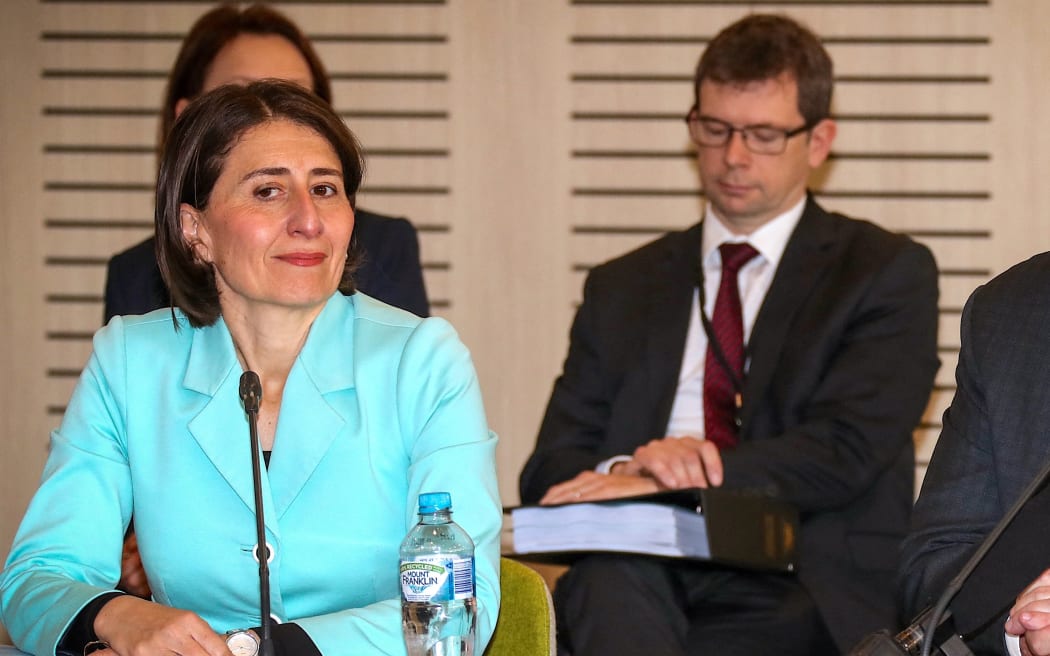 The Premier of New South Wales Gladys Berejiklian (L) reacts as Australian Prime Minister Scott Morrison speaks during the Meeting of the Council of Australian Governments (COAG) at Parramatta Stadium in western Sydney on March 13, 2020.
