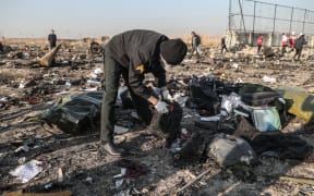 Rescuers search debris after a Ukrainian airplane carrying 176 people crashed on Wednesday shortly after takeoff from Tehran airport