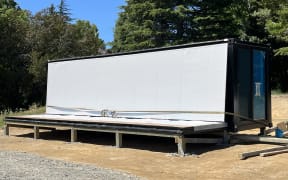 A metal veranda on a converted shipping container tiny home has collapsed at Te Pohue camp ground, injuring several people