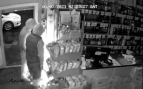 Teens use an angle grinder to break into a cigarette cabinet during the burglary of a Waikato bottle store in July.